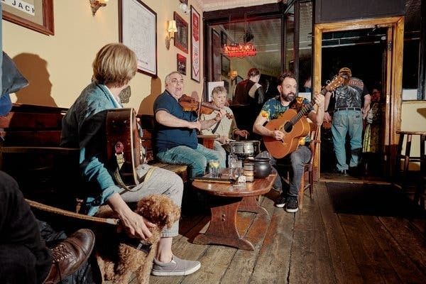 Musicians playing traditional instruments during a lively pub session